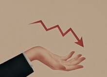 The Businessman's Hand Holds A Red Falling Arrow