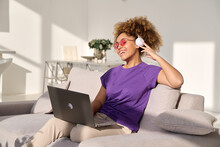 Young Black Woman With An Afro Hair Sitting At Sofa