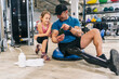 © Daniel Gonzalez/Stocksy - Athletic man with leg prosthesis and girl in gym