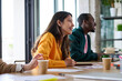 © Guille Faingold/Stocksy - Business people during  business meeting