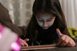 © Ezequiel Giménez/Stocksy - Girl playing game on tablet at home