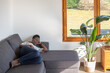 © Anna Berkut/Stocksy - black woman taking a nap on the couch at home, having rest, sleep