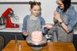 © Dima Sikorski/Stocksy - the family is happy that they cooked a cake together in the kitchen