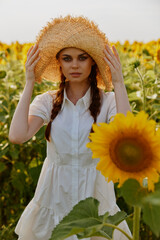 Wall Mural - beautiful sweet girl In a field with blooming sunflowers unaltered