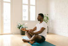 Focused Male Meditating Indoors