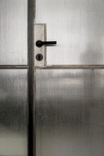Closeup View At Metal Doors With Parts From Frosted Glass