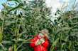 © Sergey Narevskih/Stocksy - Little girl embracing corn cob in rural field