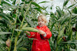© Sergey Narevskih/Stocksy - Child collecting corn in field on plant farm