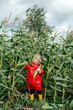 © Sergey Narevskih/Stocksy - Child touching corn ear