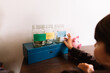 © Maria Manco/Stocksy - Child adds to Spend Save and Give Jars
