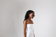 © face_reader_img - Gorgeous African American young woman wearing white dress posing in the studio.