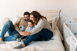 © David Prado/Stocksy - Cheerful family taking selfie on smartphone