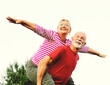 © Lumos sp - woman man outdoor senior couple happy lifestyle retirement together smiling love piggyback active mature