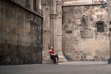 Stylish Woman Waiting At Old Cathedral Entrance