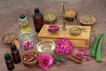 Canvas Print - Herbs and flowers for natural plant based skin treatment with brass weighing scales and essential oil bottles. Plant medicine treatment for eczema, psoriasis and acne. On rustic wood.