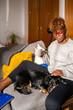 © Luis Velasco/Stocksy - Relaxed Woman Drinking A Cup Of Coffee At Home Next To Her Cute Dog.