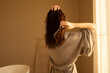 © Asya Molochkova/Stocksy - Brushing wet hair after shower