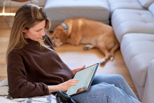 Woman Reading Article On Tablet
