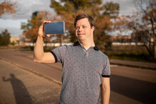 Man With Down Syndrome With Mobile Phone