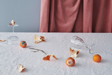 Moldy Tangerines And Glassware On Table