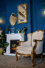 Large Antique Armchair Next To The Fireplace