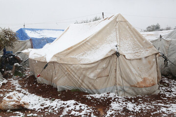 refugee tents covered with heavy snow.