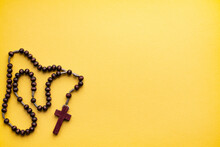 Rosary For Prayer On A Yellow Background. Catholic Hail Christian