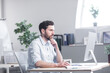 © Liubomir - Confident business man stocks broker sitting in front of monitor screen in office analyzing stat of index charts data analyses market trend. Forex trading agency worker agent reviewing profits growth
