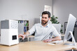© Liubomir - Happy businessman works in office hot, turns on portable small air conditioner freshener and humidifier