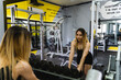A young woman is working out in the gym during the day