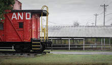 A Red Train Caboose On A Cloudy Day