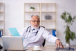 © Elnur - Old male doctor working in the clinic