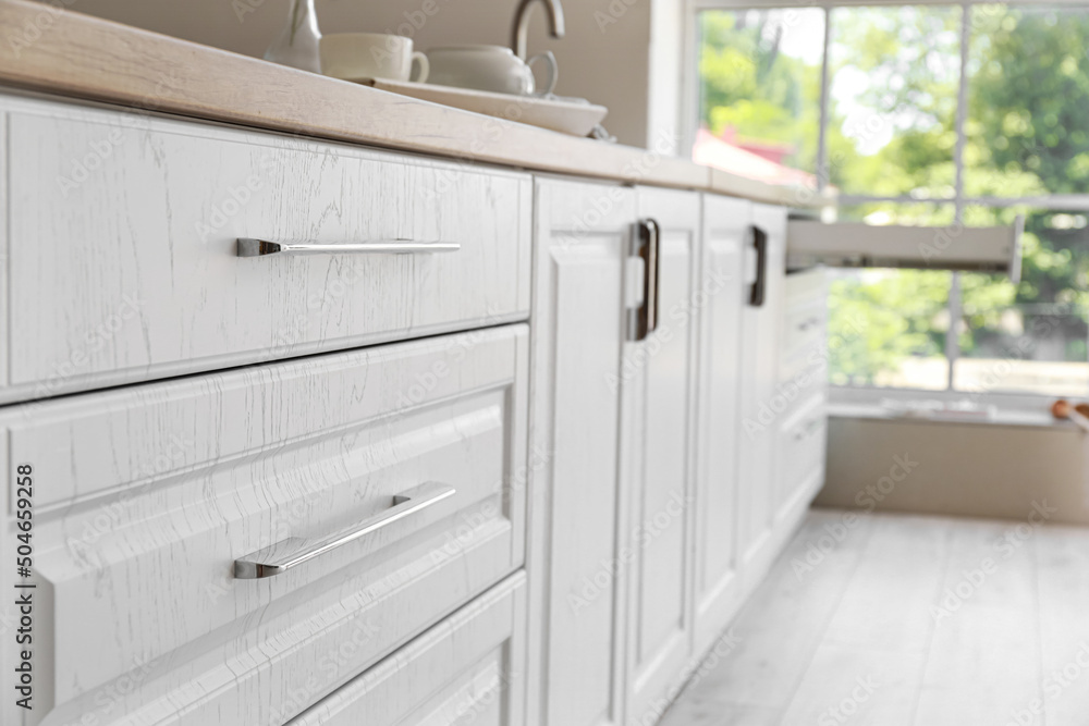 White kitchen drawers in modern room, closeup