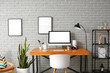 © Pixel-Shot - Interior of room with modern workplace near grey brick wall