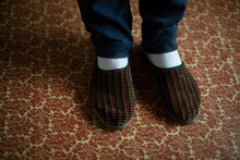Slippers On Feet. Guy's Feet Are In Slippers.