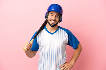 Canvas Print - Baseball player with helmet and bat isolated on pink background posing with arms at hip and smiling