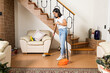 A woman sweeping a living room