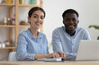 Happy diverse company mentor and African intern at office training center workplace, looking at camera, smiling. Business team coworkers, two employees, student and teacher head shot portrait