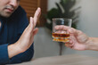 © Pormezz - person deny alcohol drink from his friend