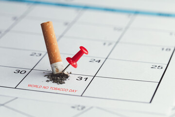 World No Tobacco Day. The cigarette broke on the May 31 calendar and had a red pin on it. the idea to stop smoking and quit smoking. world no tobacco day concept.