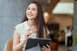 © whyframeshot - asian female freelance digital nomad career happiness workation cheerful smiling working online with smart device tablet smartphone abroad occupation project work anywhere new frameless lifestyle cafe