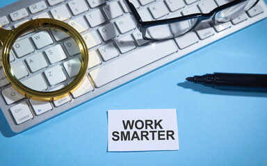 Sticker - Work Smarter text on paper with a business objects.