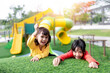 © FAMILY STOCK - Child playing on outdoor playground. Kids play on school or kindergarten yard. Active kid on colorful slide and swing. Healthy summer activity for children. Little girl climbing outdoors.