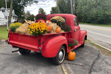 A Classic Old Truck Filled With Halloween Season Flowers Hay And Festive Fall Orange Pumpkins