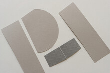 Silver Paper Shapes Arranged On A Paper Background