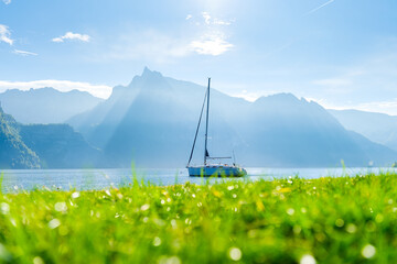 Wall Mural - a yacht against the backdrop of the mountains in switzerland. calm water and bright sunny day. a pop