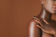 Cropped image of young Black woman applying moisturizing body oil after shower