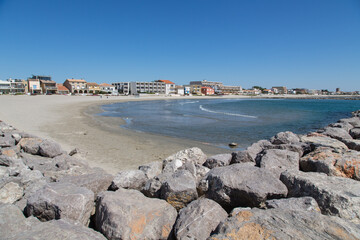 Wall Mural - Beach landscape France: Moles with huge stones surrounding the sandy beach of Carnon-Plage near Montpellier with its beautiful clear water and protecting the waterside family friendly vacation rentals