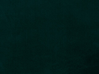 Dark green old velvet fabric texture used as background. Empty green fabric background of soft and smooth textile material. There is space for text.