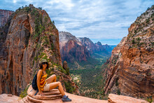 A Young Woman On Top Of The Trekking Of The Angels Landing Trail In Zion National Park, Utah. United States